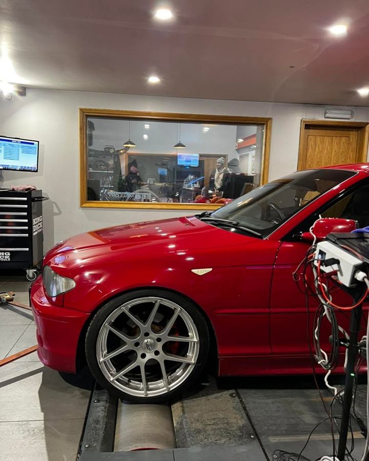 Red BMW 3 Series on the rolling road